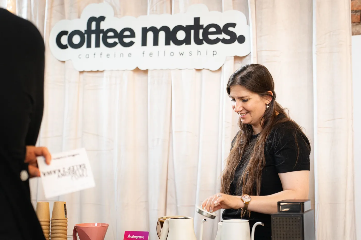 Honorata brewing coffee at the Coffee Mates stand